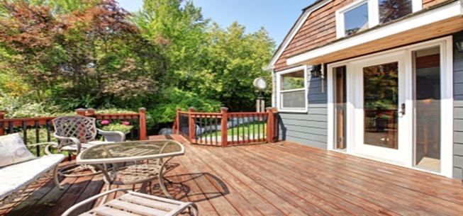 A deck with chairs and tables in the middle of it