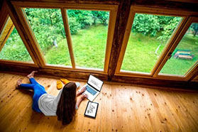 A person sitting on the floor with their laptop